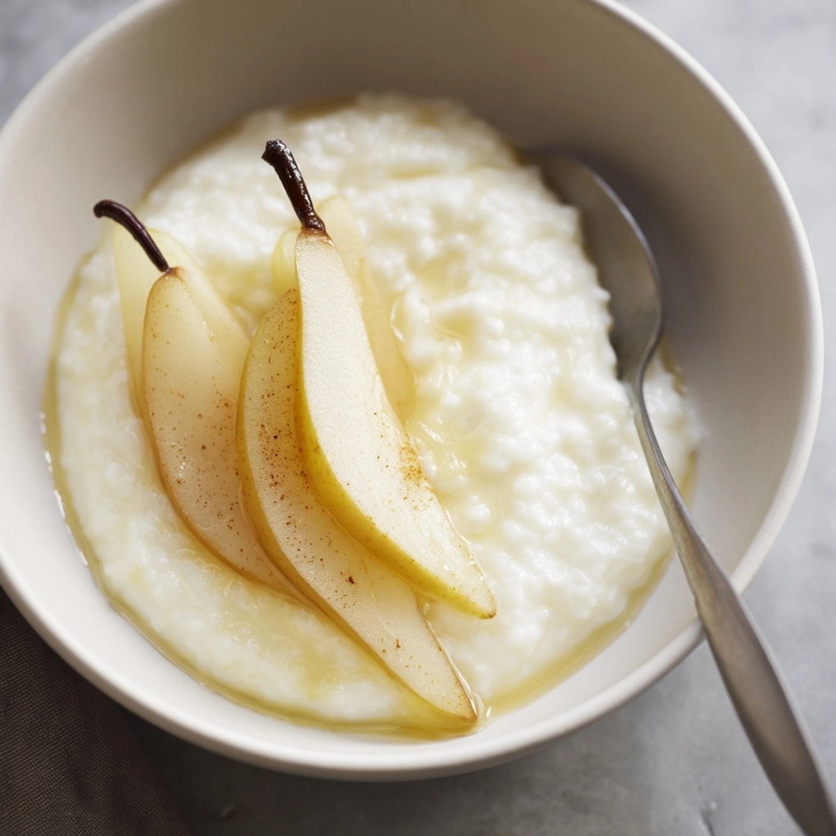 Sweet Ricotta with Fresh Fruit: Creamy, honey-sweet ricotta topped with juicy pear slices, ready to enjoy.
