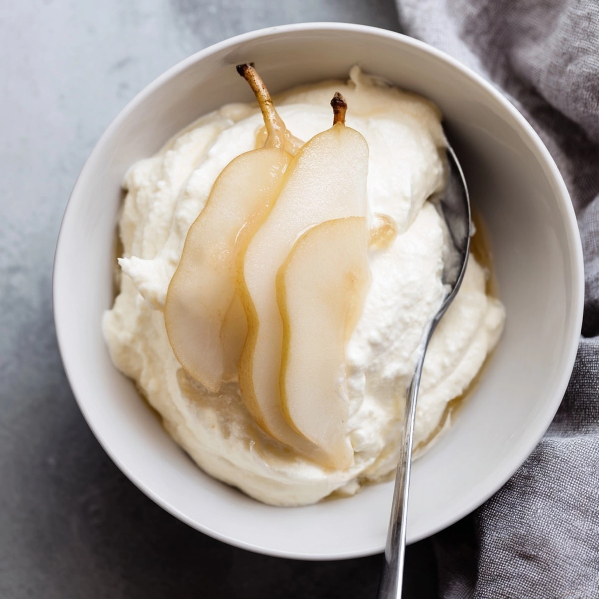 Homemade Sweet Ricotta with Fresh Fruit featuring velvety texture and colorful sliced pear garnish.