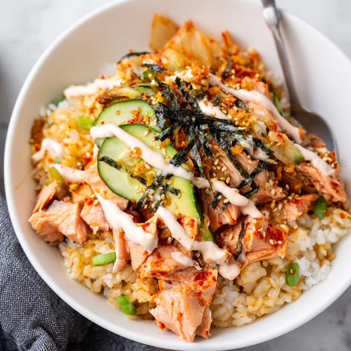 Flavorful bowl of crispy salmon, tangy kimchi, and fluffy rice awaits you.  