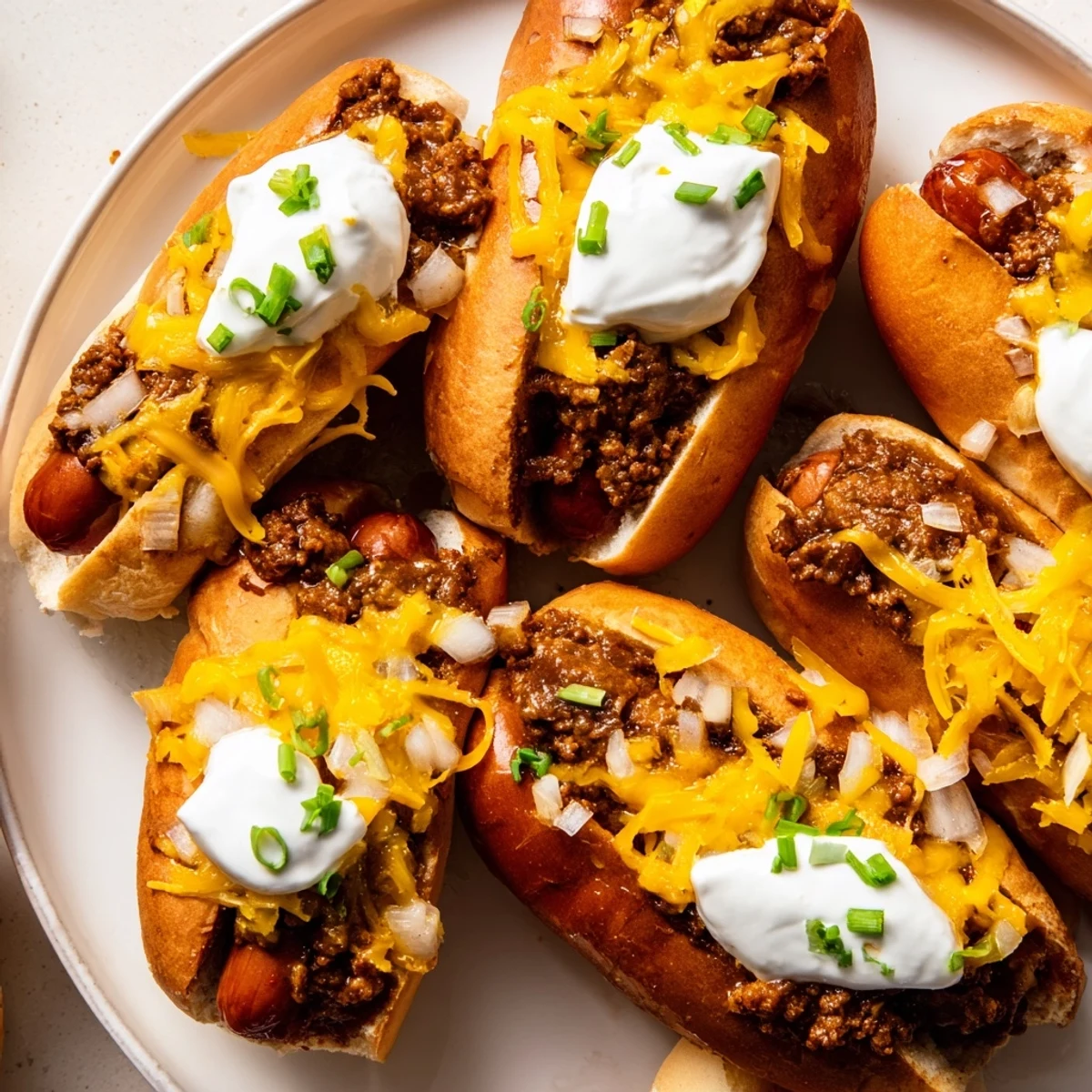 Golden-brown, bubbly Chili Dog Casserole, loaded with shredded cheese and delicious hot dogs.