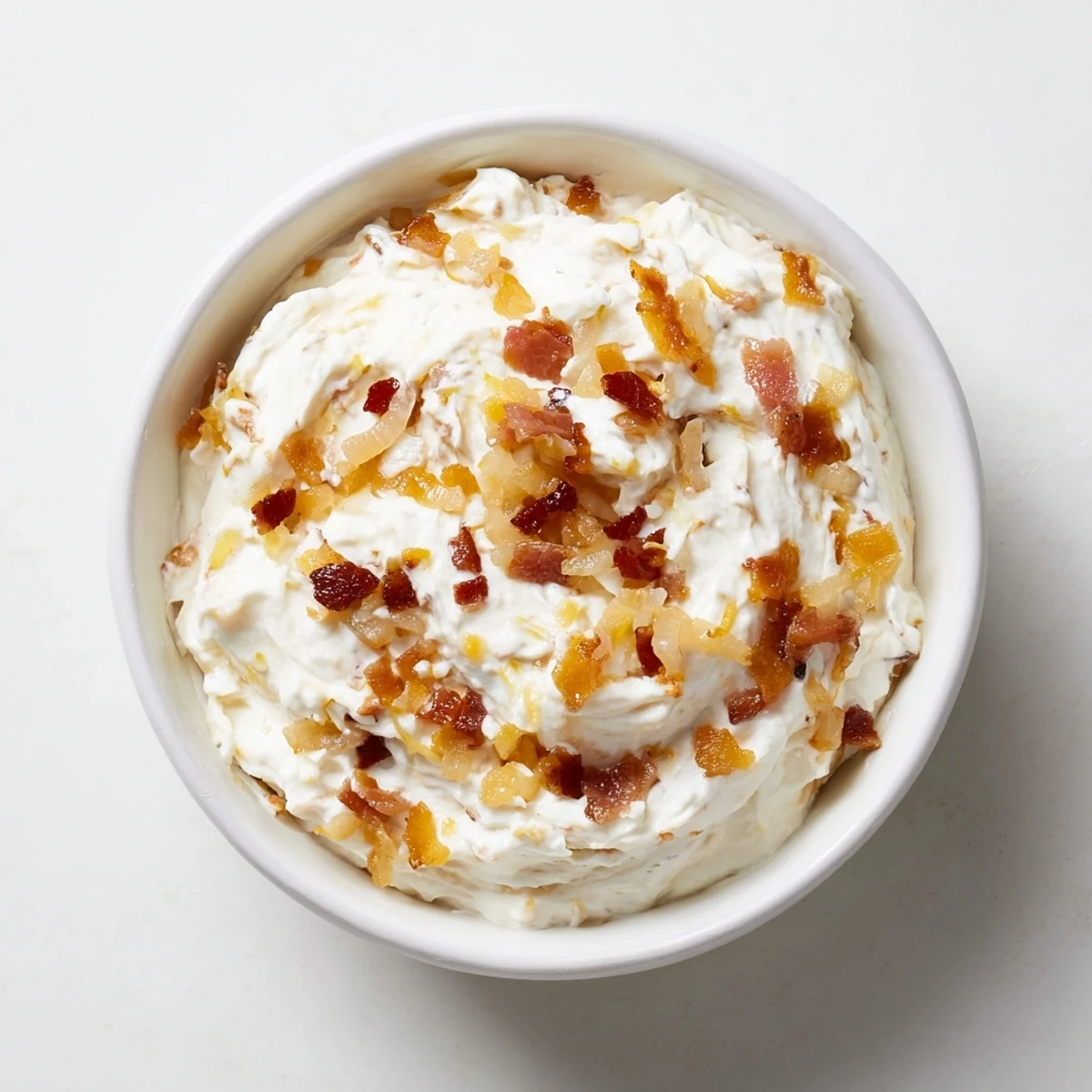 Smoky bacon bits mingle with sweet onions in this irresistible caramelized onion dip.