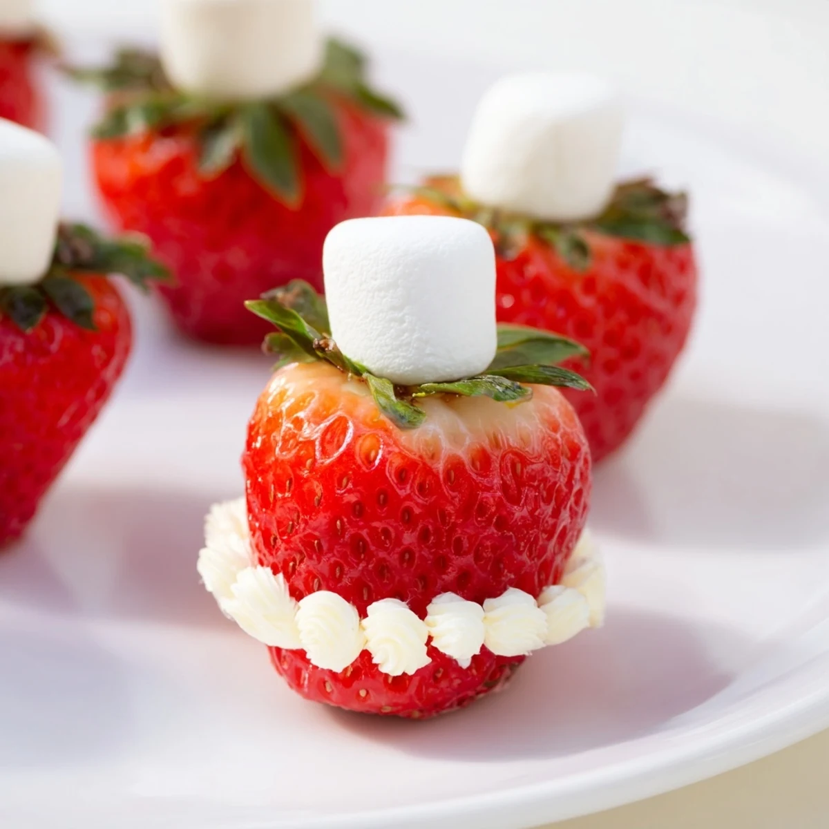 Fresh, juicy Air Fryer Santa Hat Strawberries, perfectly arranged with a creamy, sweet topping and mini marshmallows.