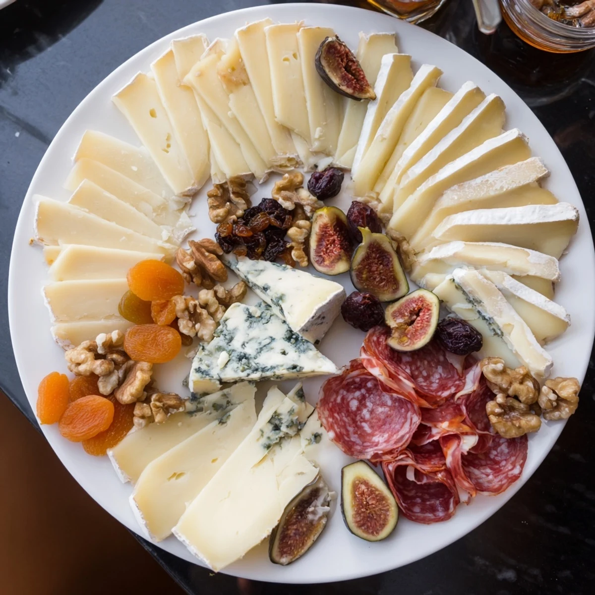 Beautifully arranged Plateau des Rois Mages Gourmand appetizer: creamy cheeses, cured meats, and sweet treats.