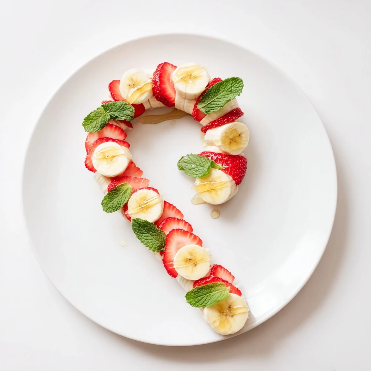 Picture a playful Banana Strawberry Candy Cane: a fun, easy, and healthy kids' snack, beautifully presented.