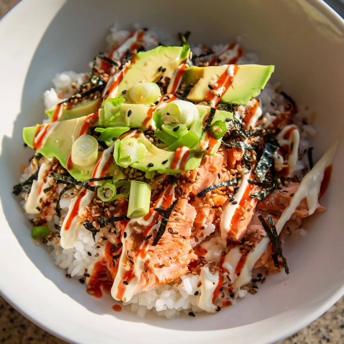 Flaked salmon and fluffy rice combine in this beautifully plated Classic Salmon Rice bowl.