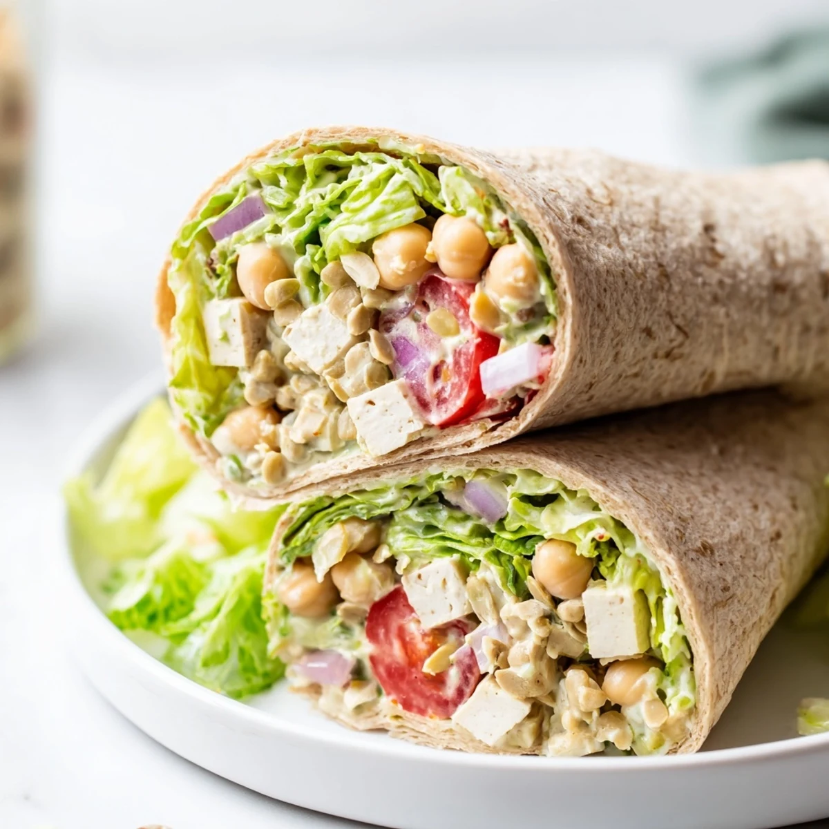 A fresh High-Protein Chicken-less Caesar Wrap, ready to eat, bursting with colorful vegetables and plant-based protein.