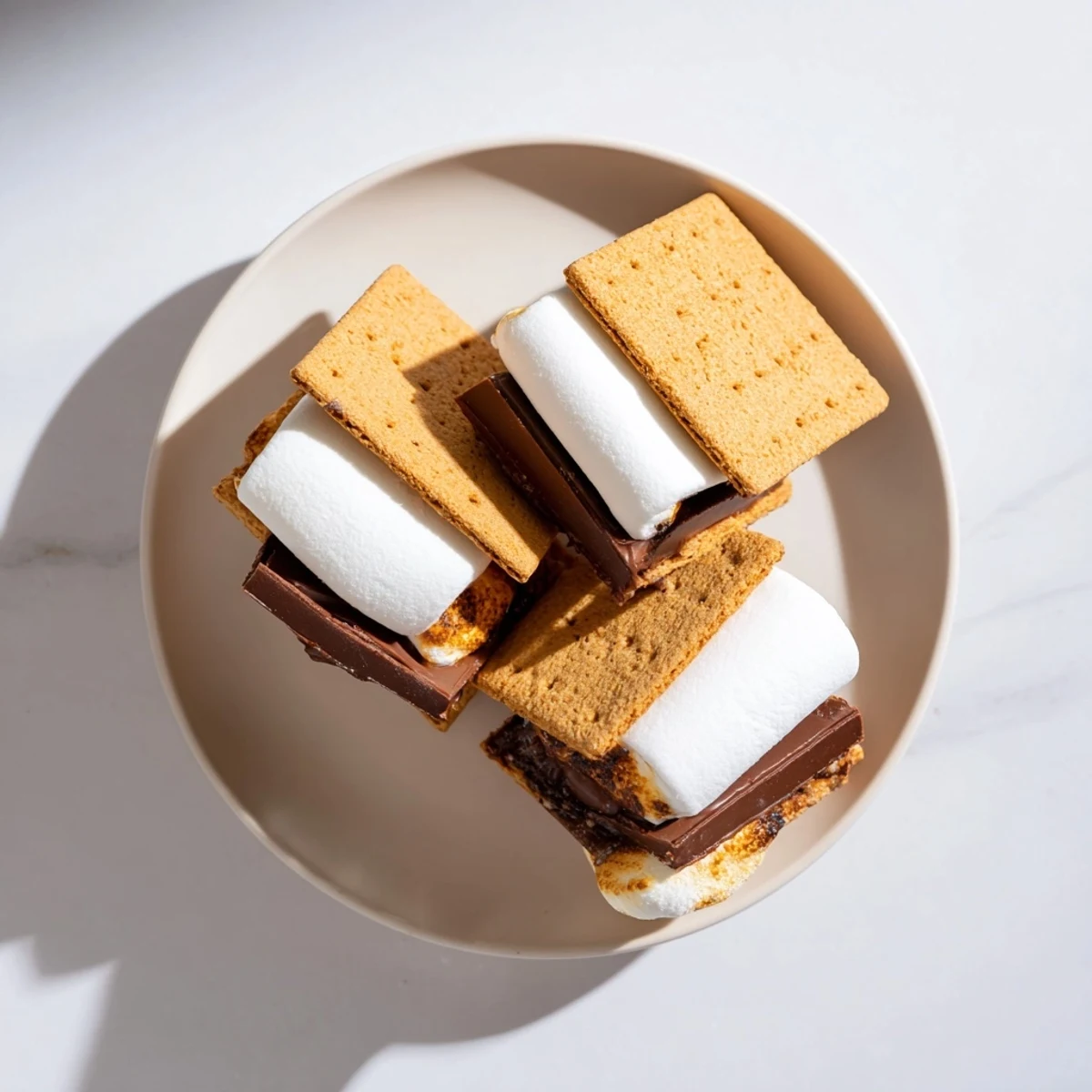Quick air fryer s'mores recipe stacked high, melted chocolate and toasted marshmallows between crunchy graham crackers.