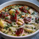 Hearty one-pot meal featuring diced ham, white beans, potatoes, and fresh parsley in a velvety cream soup.  