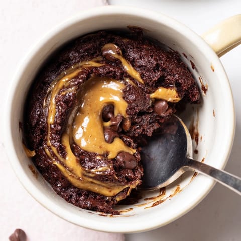 Easy Peanut Butter Chocolate Mug Cake, steamy and fragrant, perfect for late-night cravings.