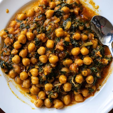 Aromatic chickpea and spinach curry simmered in creamy coconut goodness, perfect for dinner.  