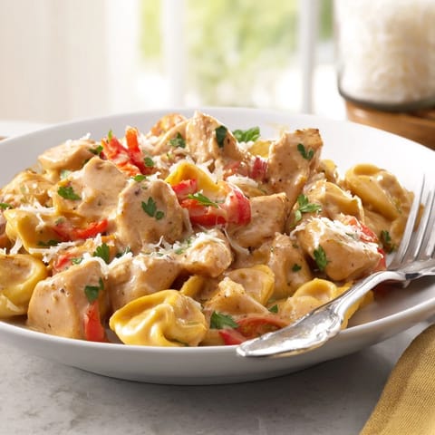 Delicious Zesty Cajun Garlic Parmesan Chicken Tortellini served with crusty bread for dipping.  