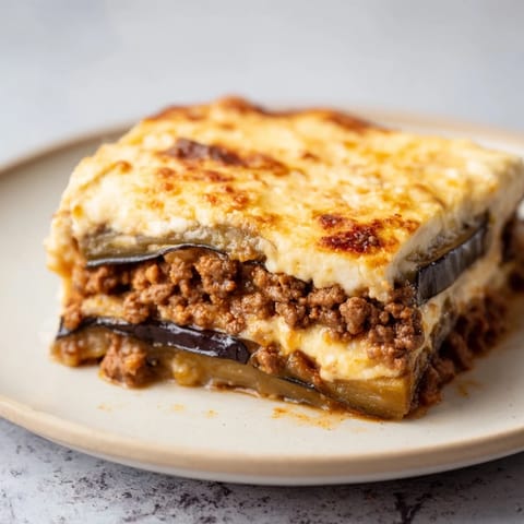 A close-up shot of the savory Moussaka, showing the rich, spiced beef and baked eggplant.