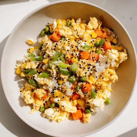 Savory Frozen Veggie Fried Rice with Egg: golden rice, flecks of green onions, and flavorful soy sauce.