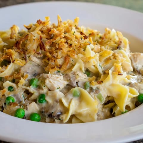 Bubbling hot Tuna Noodle Casserole with a crispy onion topping; smells delicious from the oven.