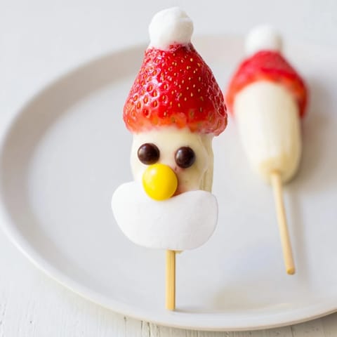 Delicious Banana Santa Snack Sticks: ripe banana slices with fresh strawberry hats are easy to make.
