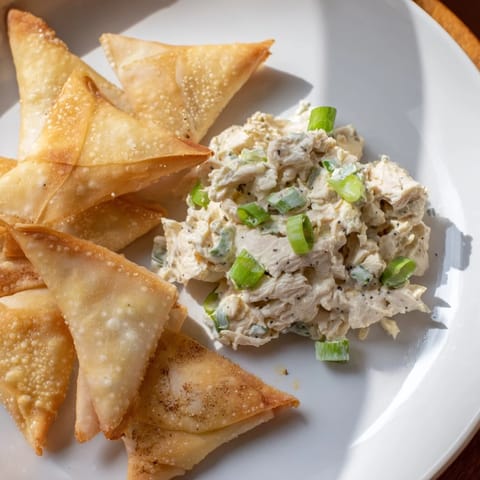 This plate features the savory air fryer lumpia chips, ready to dip into chicken cream cheese goodness.