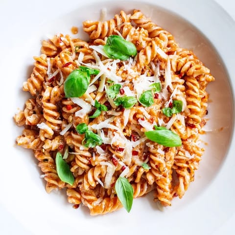 A close-up of the delicious Basil Garlic One-Pot Creamy Tomato Pasta, garnished with fresh basil.