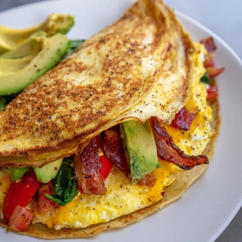 This crispy breakfast wrap looks amazing, layered with savory filling and perfectly folded before cooking.