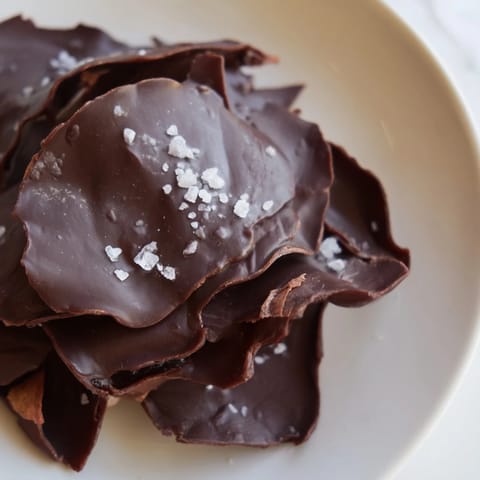 Homemade chocolate potato chip bark with a glistening chocolate layer and salty potato chips.
