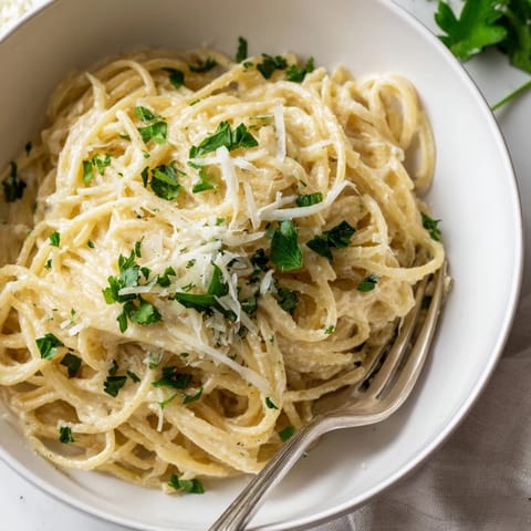 Quick weeknight Lemon Ricotta Pasta tossed with olive oil and garlic, served steaming in a rustic kitchen.  