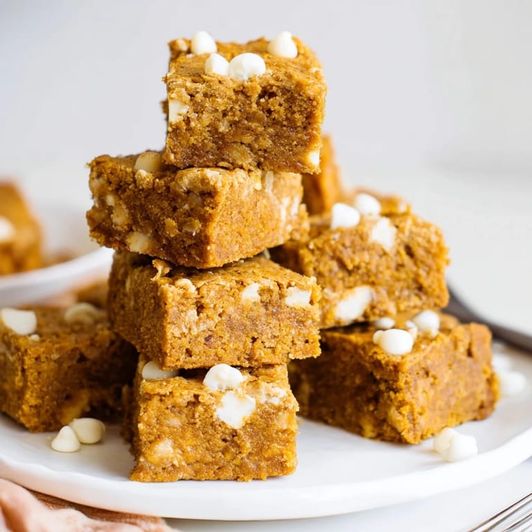Delicious pumpkin muffin white chocolate chip bars, perfect for cozy autumn gatherings.  