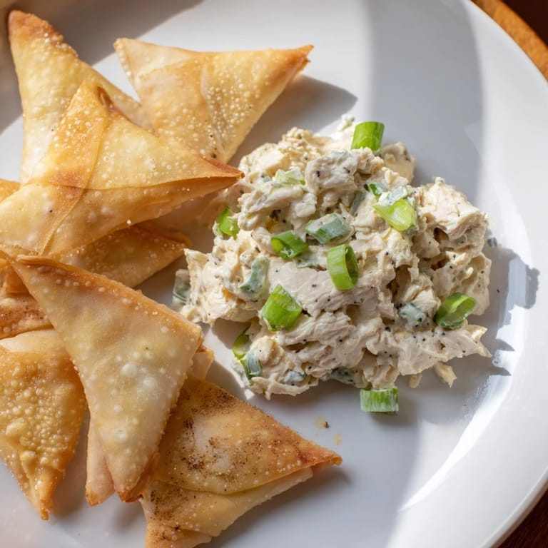This plate features the savory air fryer lumpia chips, ready to dip into chicken cream cheese goodness.