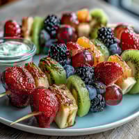 Fun Kid Lunch Bento Box with Fruit Skewers and Dip, featuring colorful fruit kabobs, creamy yogurt dip, and wholesome sandwich bites—perfect for school lunches.